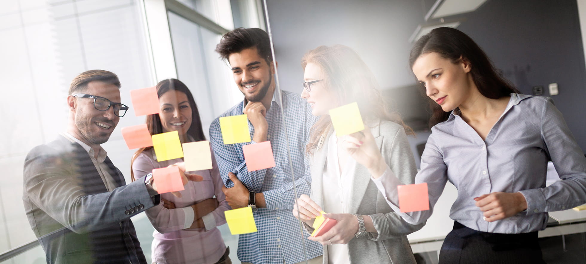 Vier Personen am Arbeiten mit Notizzettel