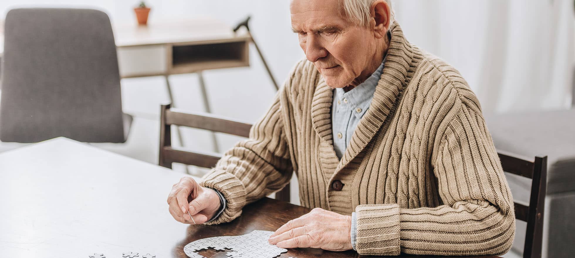 Old man doing a puzzle